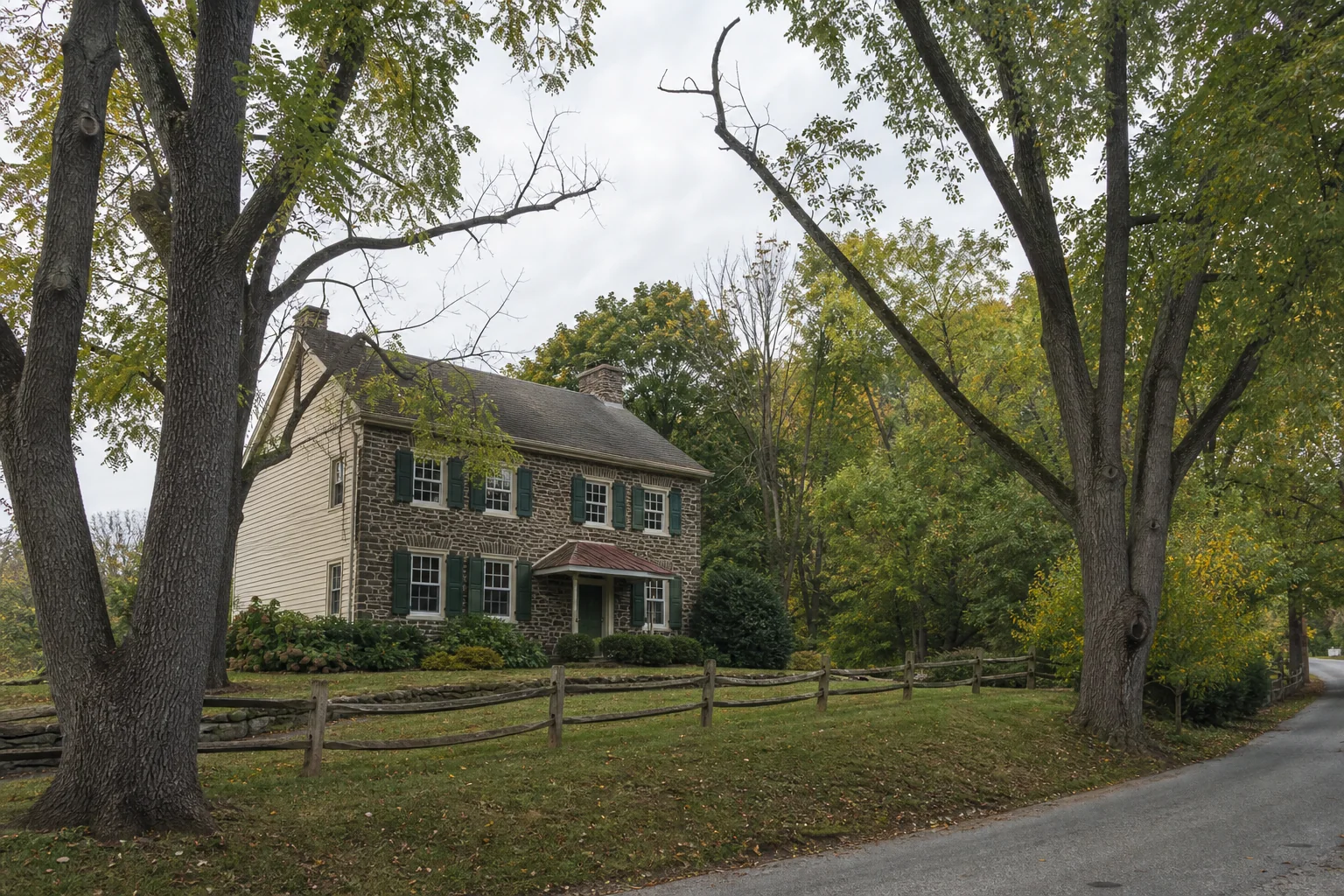 Fogelsville area stone-and-siding home beside a village road and mature wooded trees