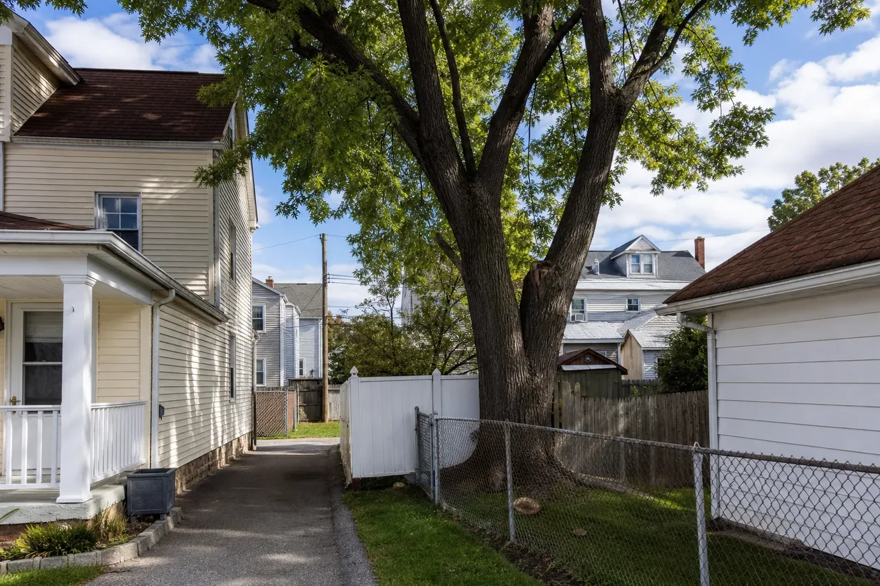 Close-set homes with mature trees near roofs and fences in the Allentown area